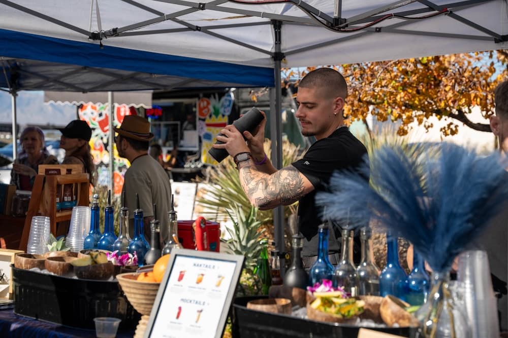 Etienne shaking a drink at a Lumanai booth